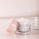 Louis Widmer Hydraderm Dagemulsie UV 30 Licht Geparfumeerd 50ML Lichtroze achtergrond met product